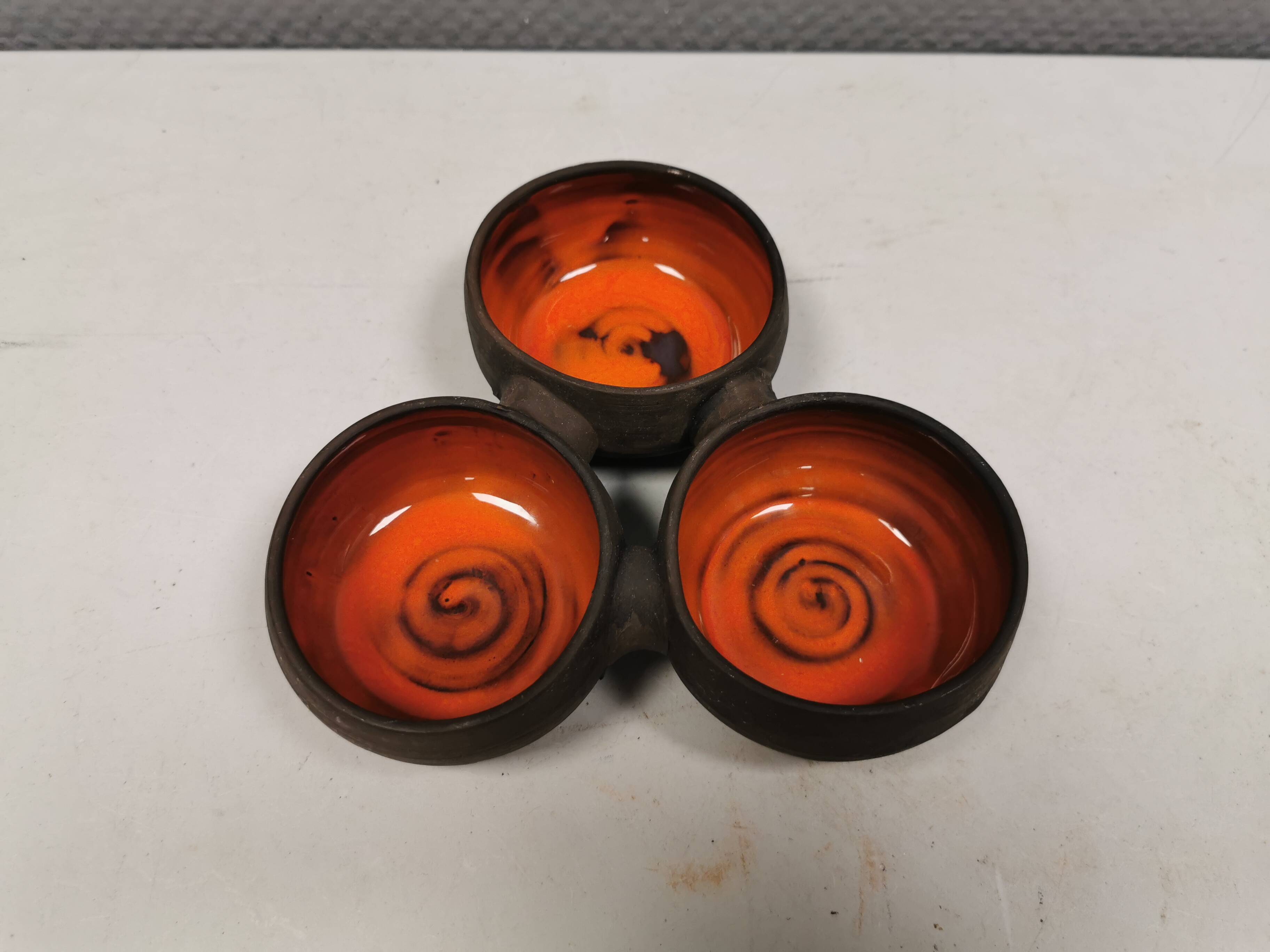 Beautiful bowl (composed of 3 bowls) with orange/red glaze inside