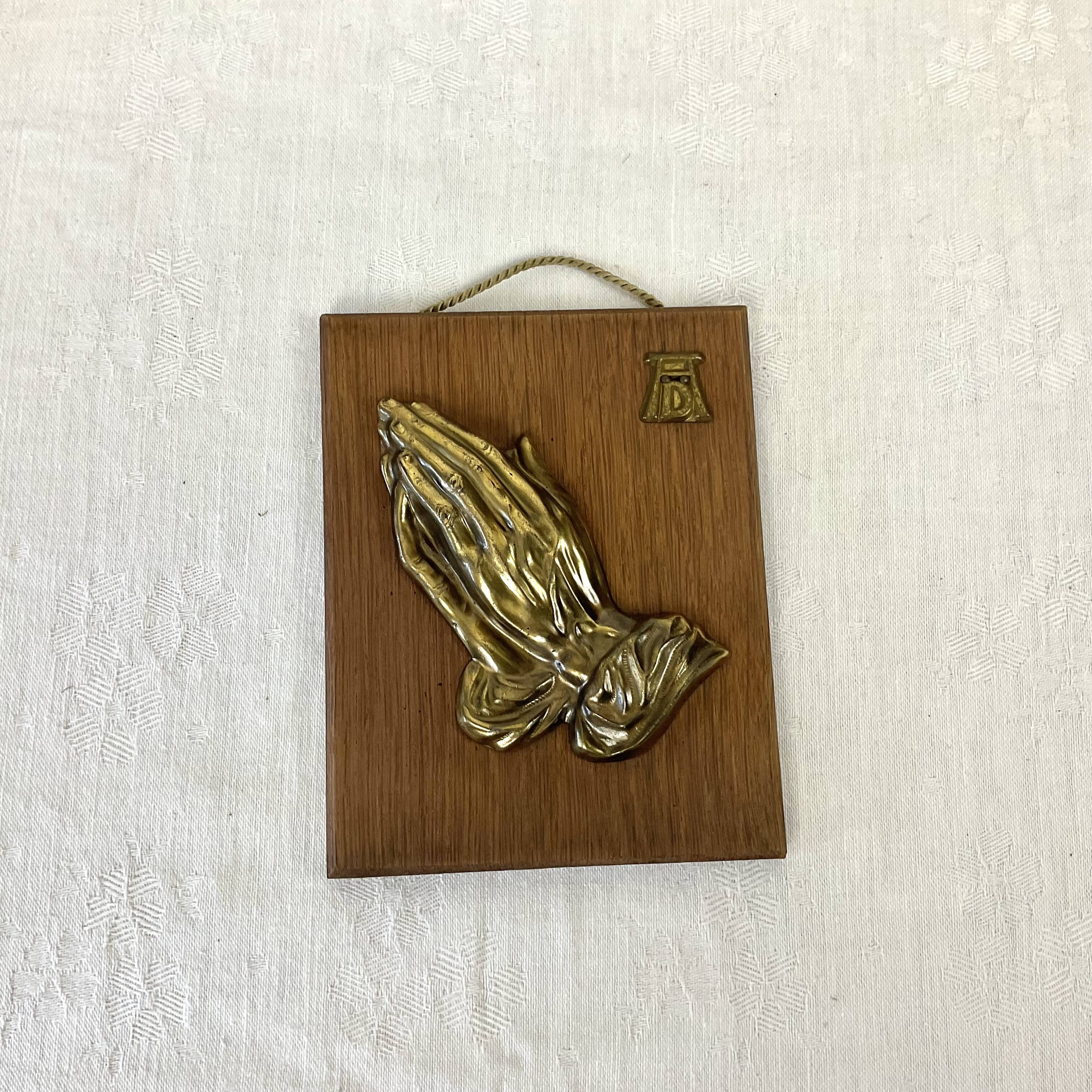 Suspension of praying hands