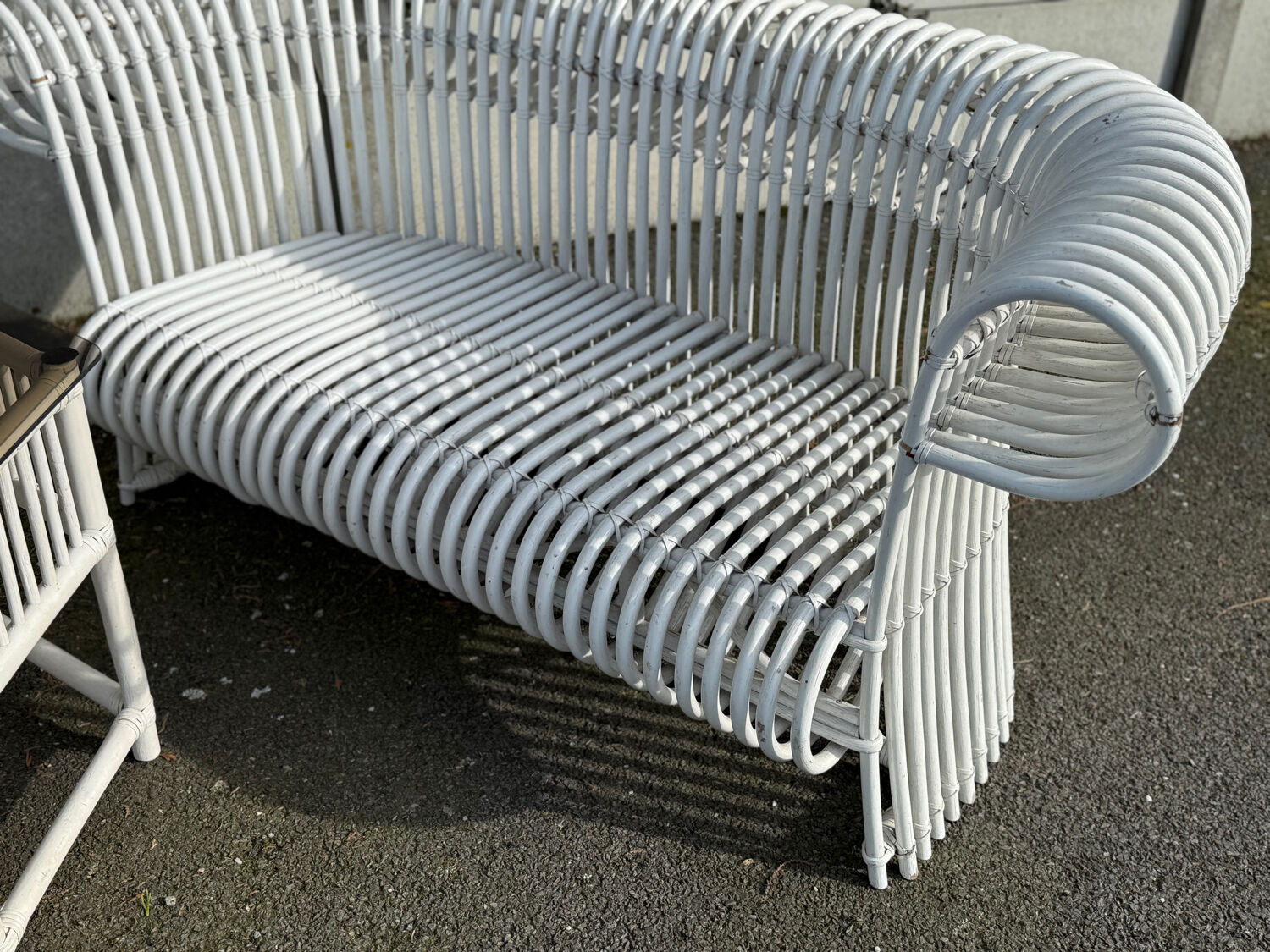 Rattan lounge with two two-seater sofas and a white coffee table.