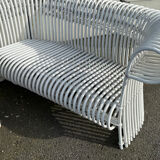 Rattan lounge with two two-seater sofas and a white coffee table.