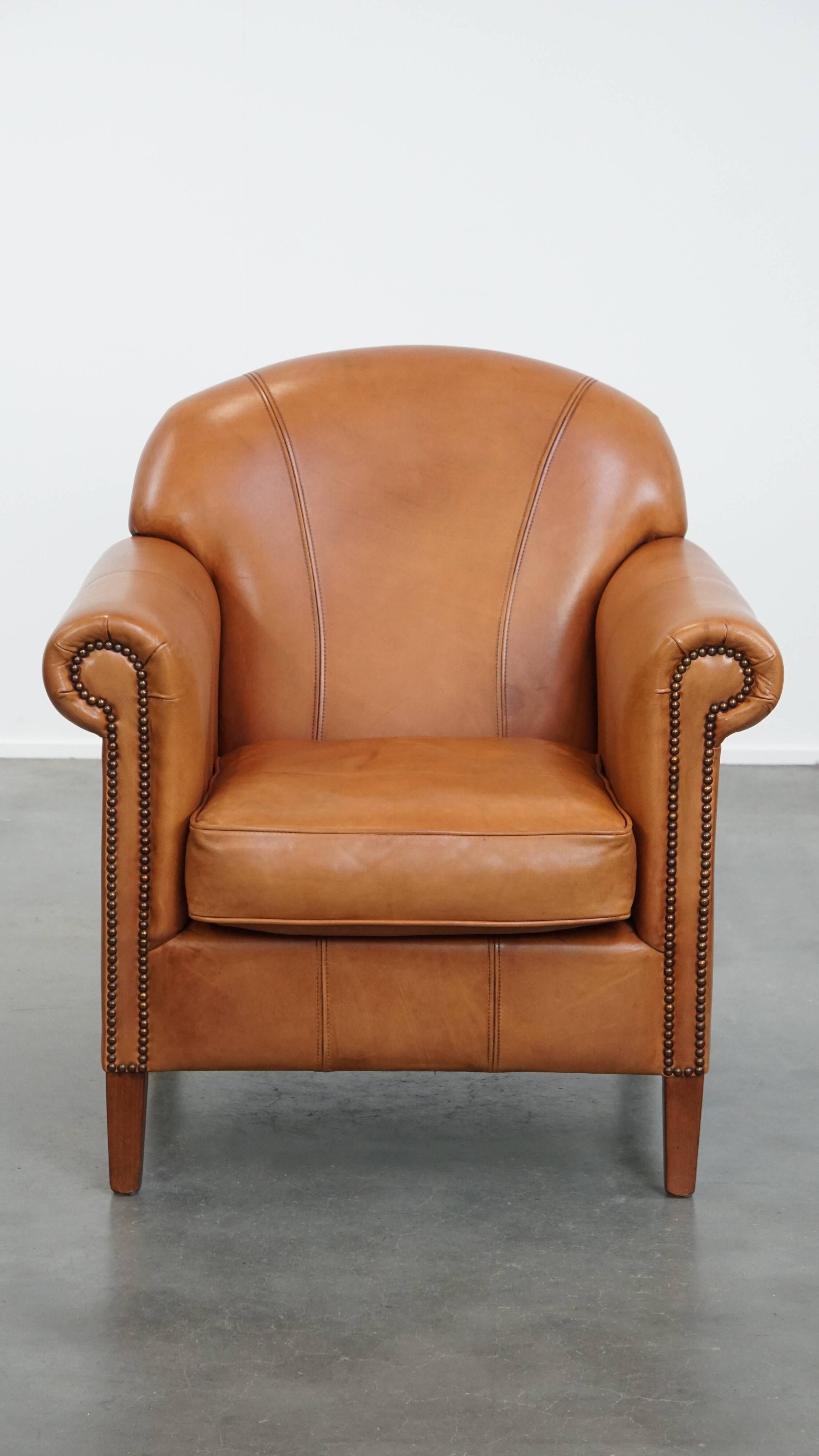 Cognac-colored cowhide leather armchair