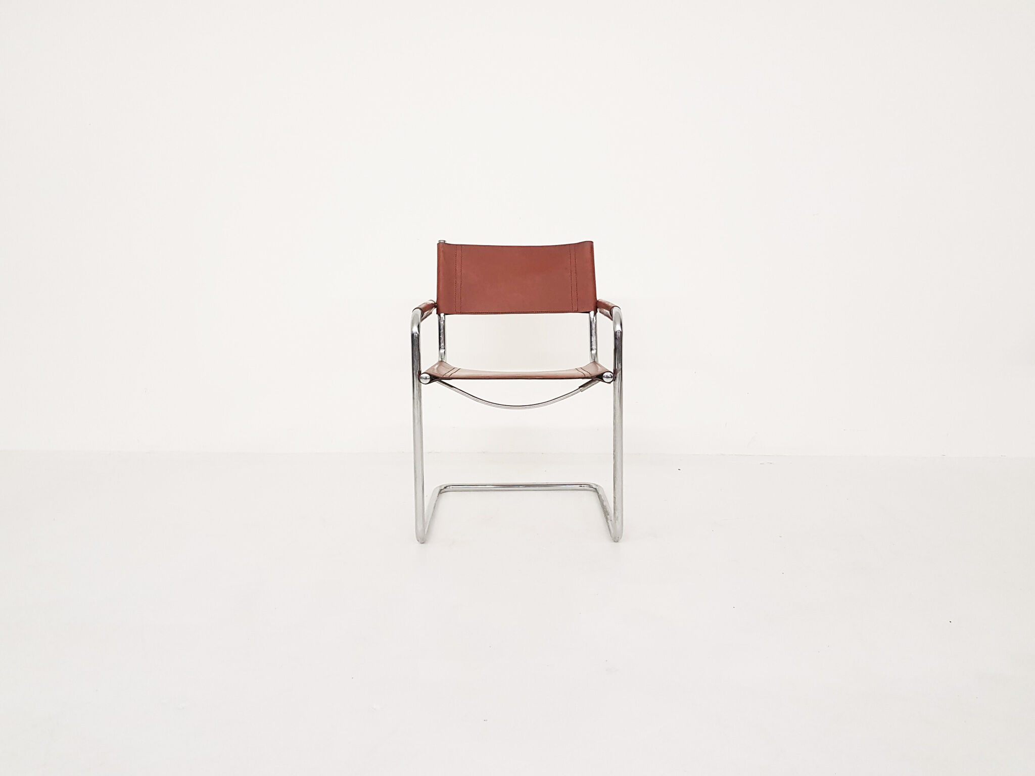 Tubular dining chair with arm rests, 1970's