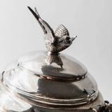 Vintage 1930s silver-plated footed bowl with lid by Warren Rogers New York, featuring a bird motif and ornate details.