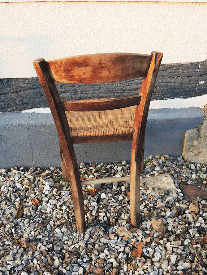 Old woven straw children's chair