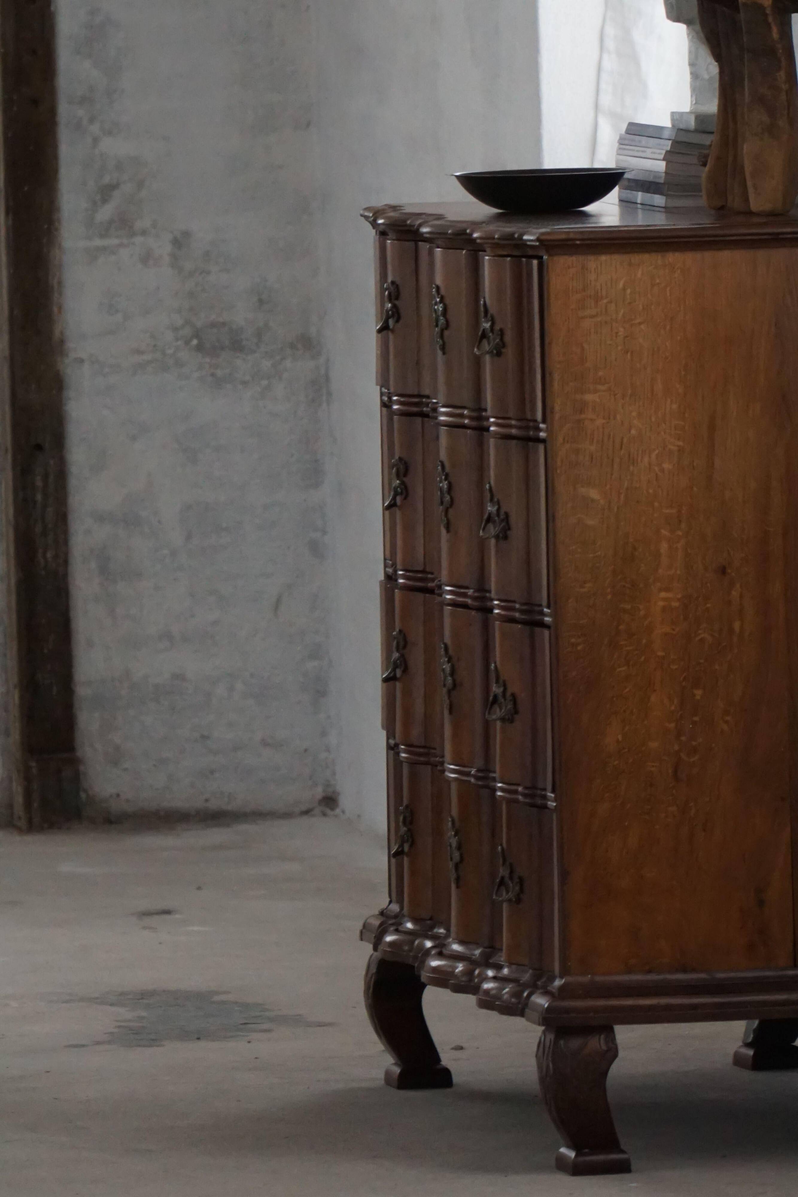 Antique baroque oak commode from the late 18th century with cabriole legs.
