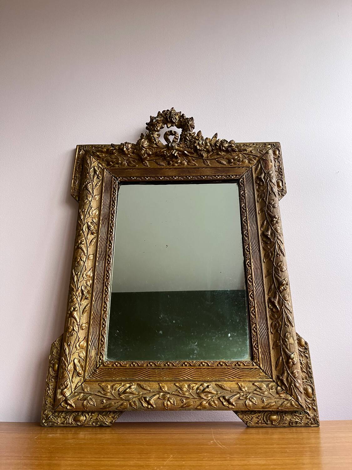 Golden trumeau mirror for fireplace, late 19th century, with sculpted pediment.