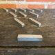 Set of 11 vintage aluminium knife rests from the 1970s