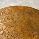 Round Art Nouveau coffee table with a sculpted top.