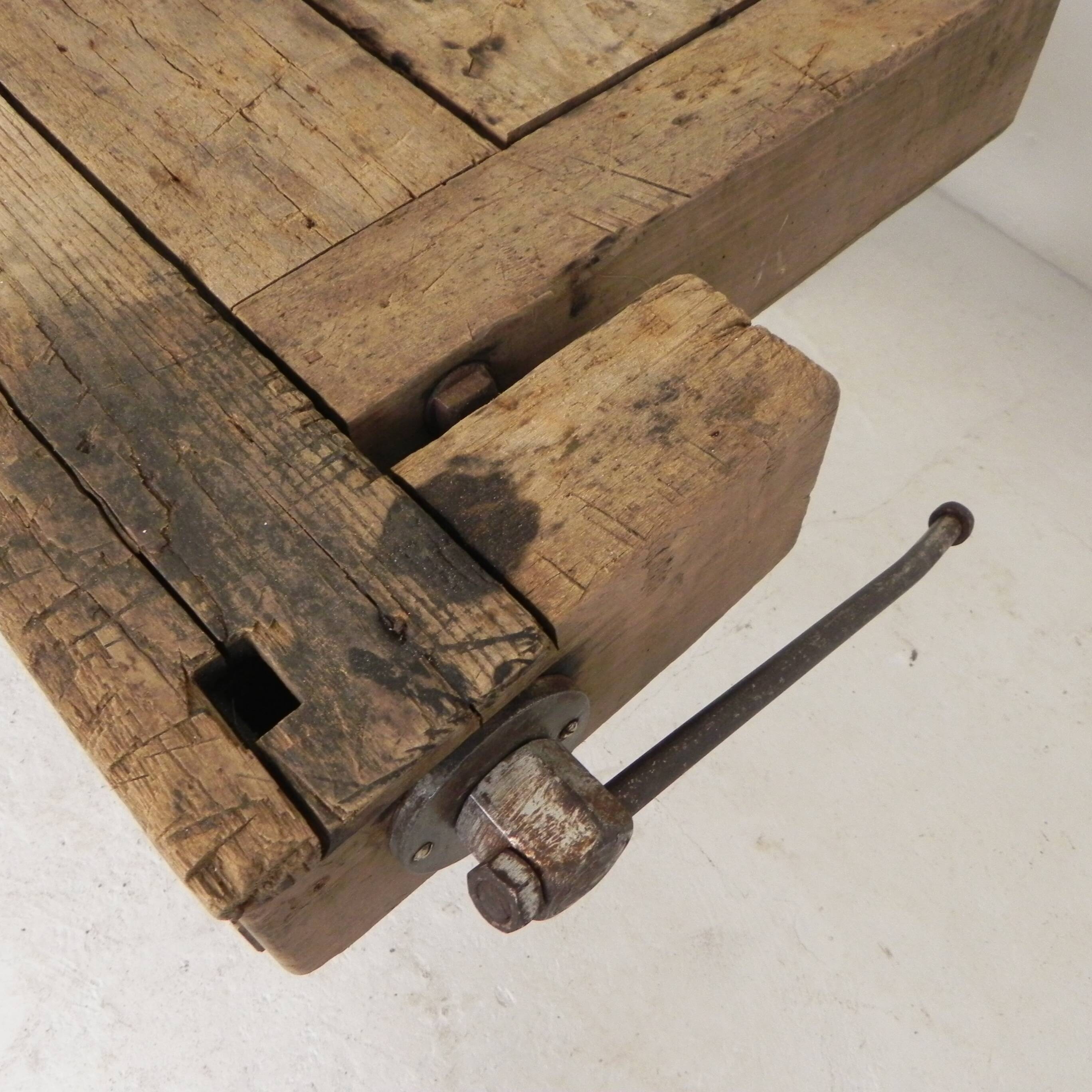 Wooden industrial workbench with vice, 194 cm long, 1930s.