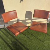 A pair of vintage brown Skaï chairs.