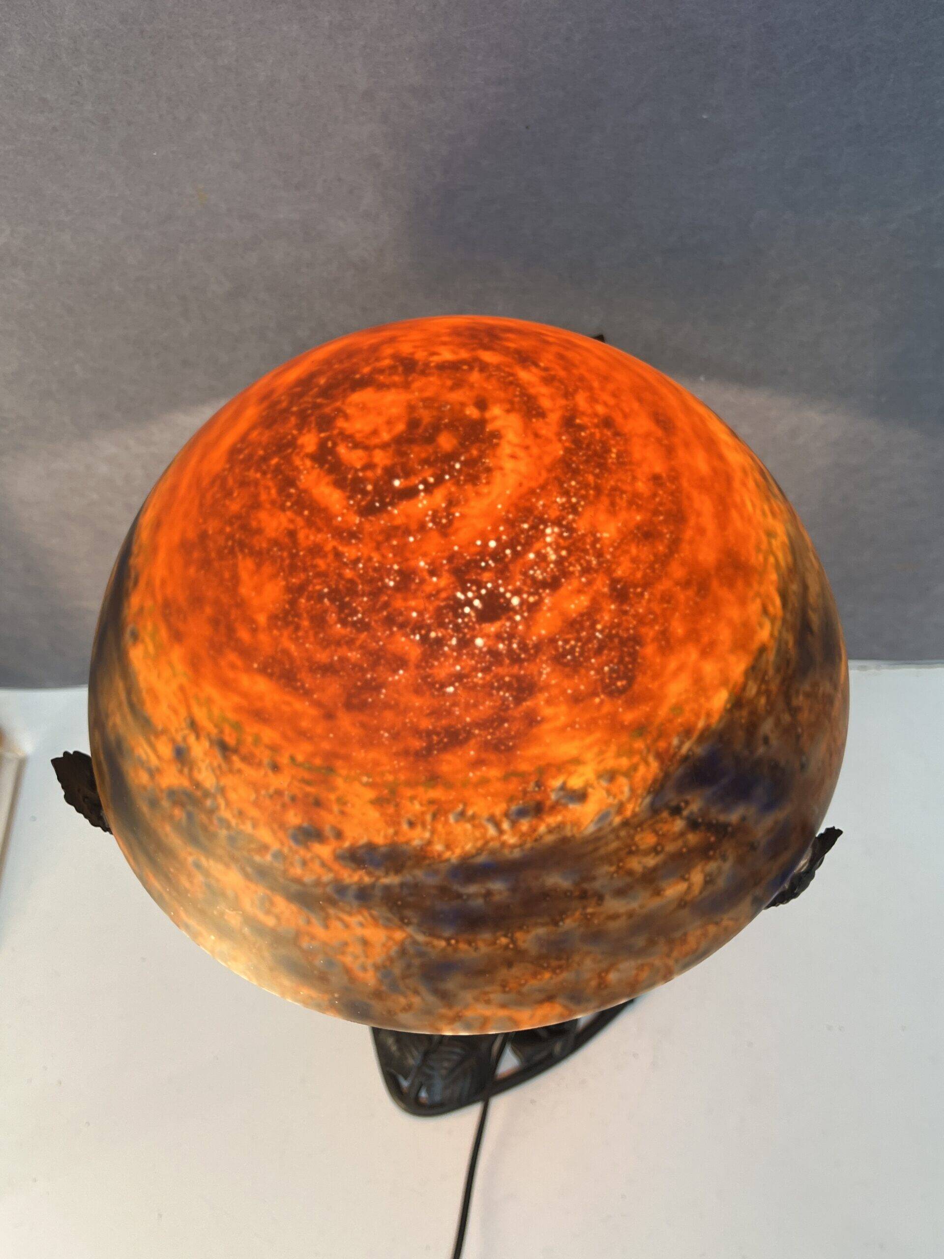 Contemporary mushroom lamp, wrought iron base and shaded orange glass shell