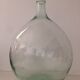 Transparent old demijohn about 8 to 10 L