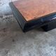 Vintage coffee table in wood burl on a black lacquered base.
