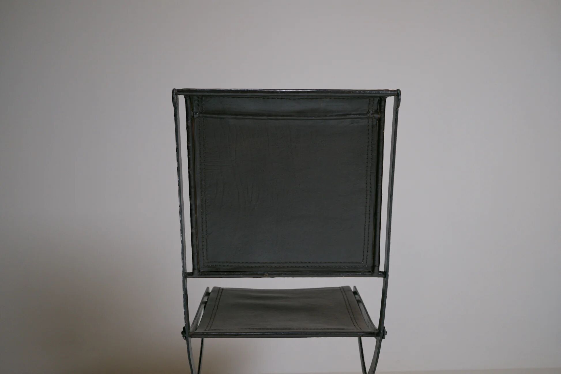 Foldable chair in wrought iron and leather. c. 1950