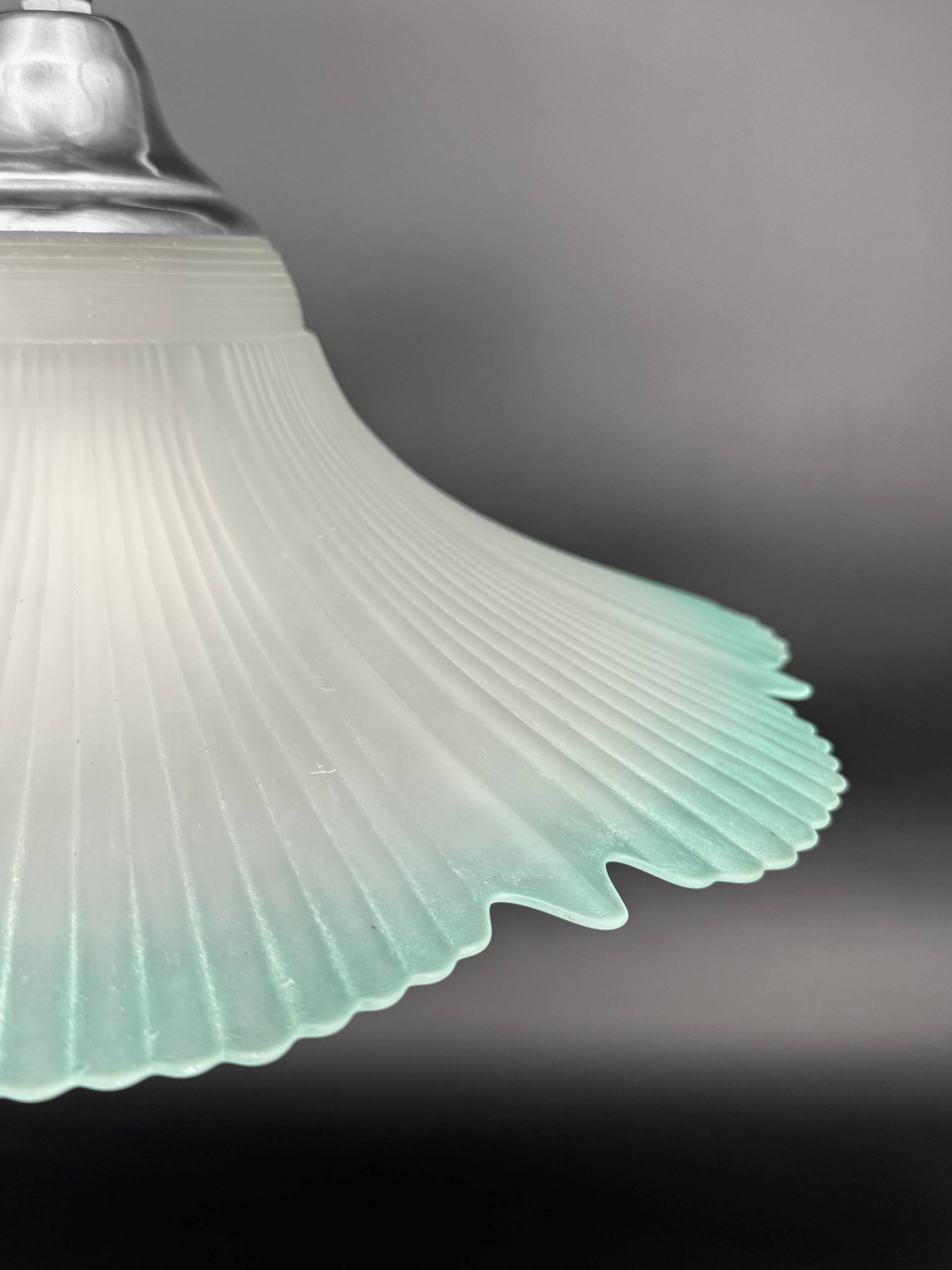 Frosted glass flower pendant with a water green edge.