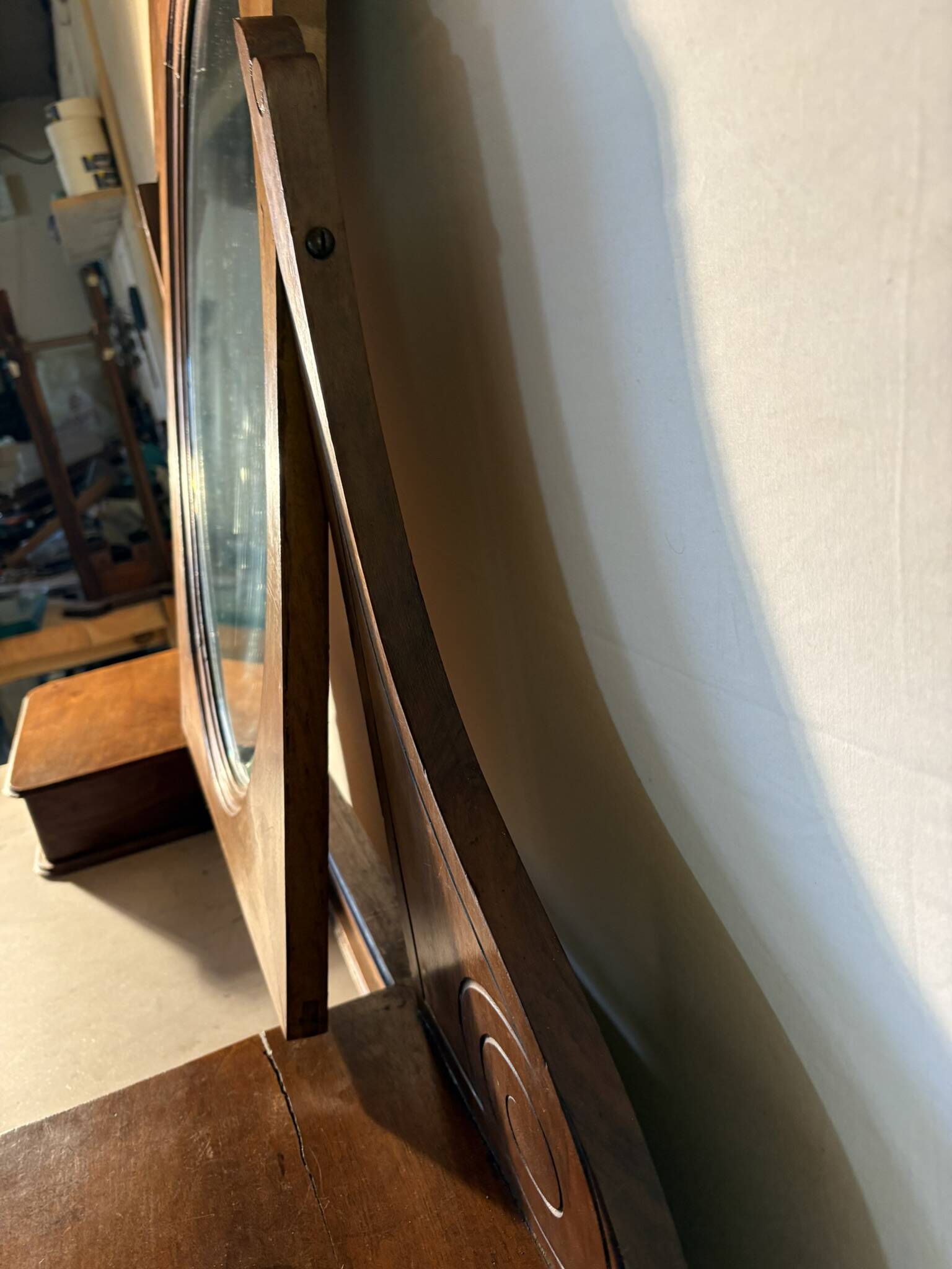 Antique carved wooden dressing table with marble and tilting oval mirror.