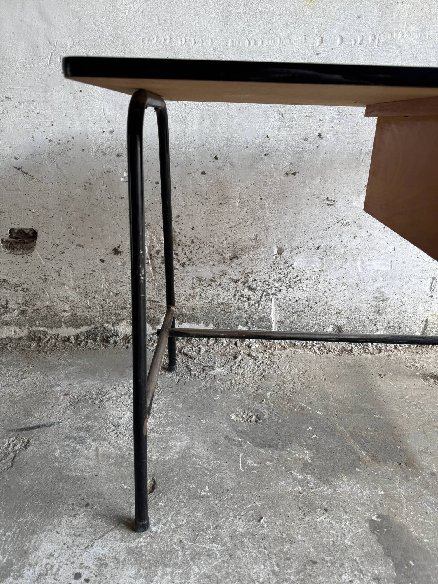 Black metal and wood mid-century industrial desk with laminated top and two drawers