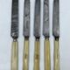 Set of 5 dessert knives with ivory handles.
