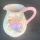 Glazed ceramic slip jug with vintage basket and fruit motif