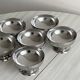 Set of 6 low footed bowls in mirror stainless steel.