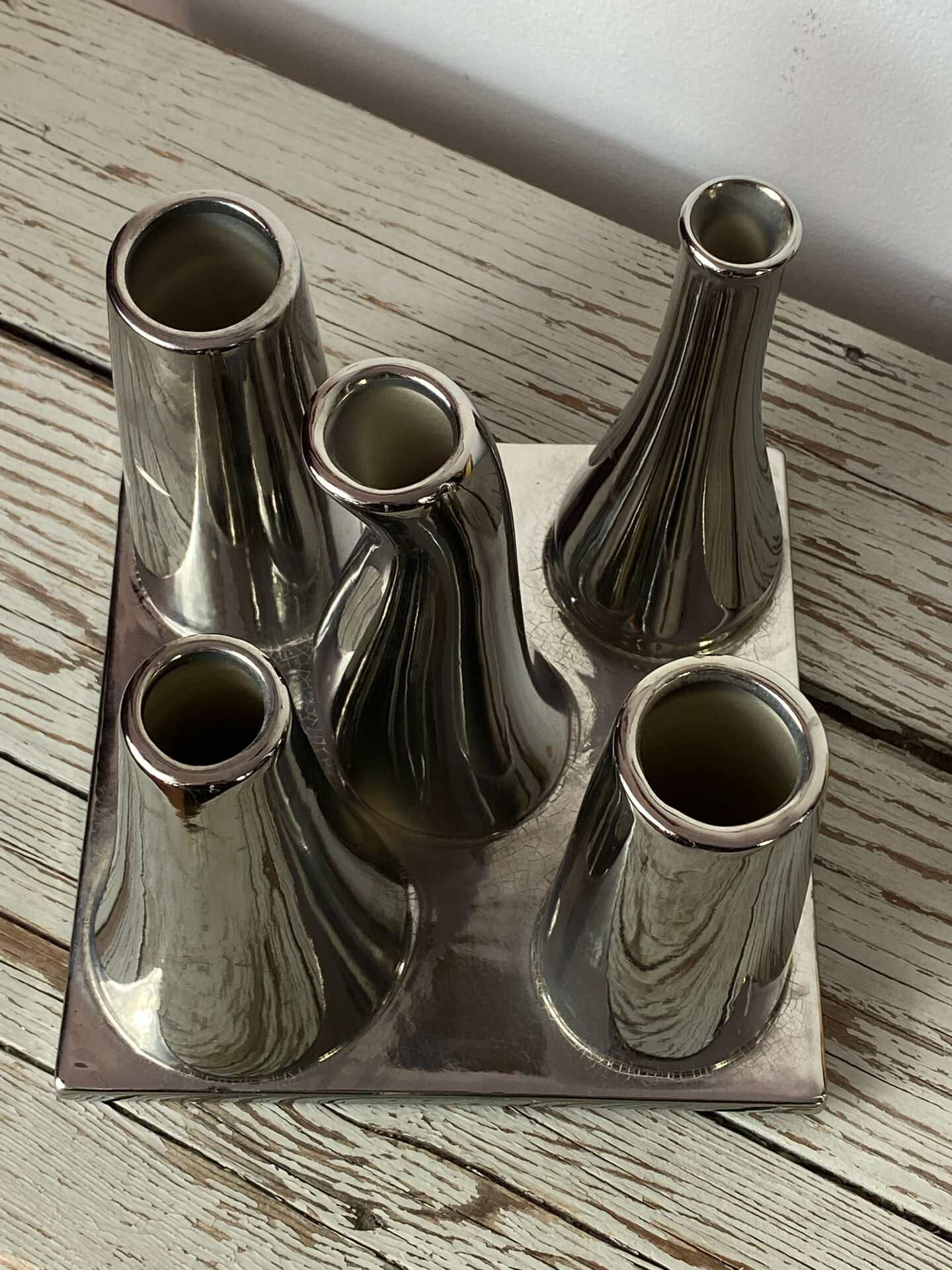 Asymmetrical multitube vase on a base, in silvered ceramic, 1970.