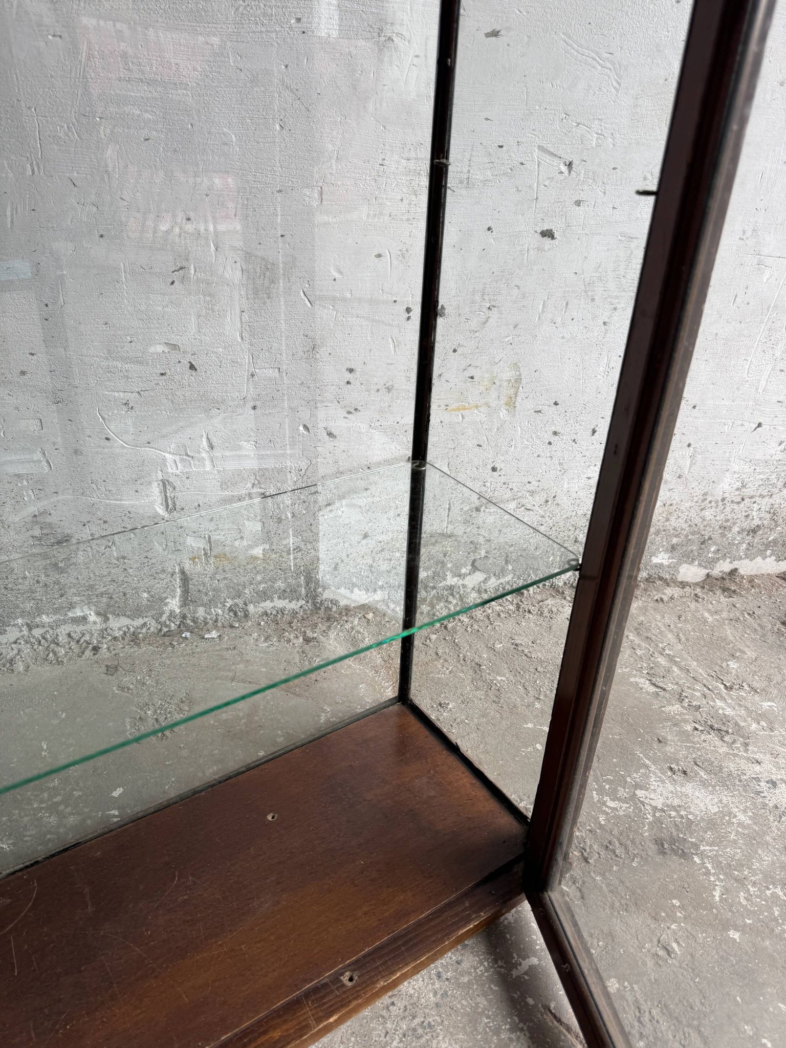 Dark-stained wood and glass vintage display cabinet — early 20th-century wall-mounted showcase