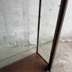 Dark-stained wood and glass vintage display cabinet — early 20th-century wall-mounted showcase
