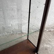 Dark-stained wood and glass vintage display cabinet — early 20th-century wall-mounted showcase