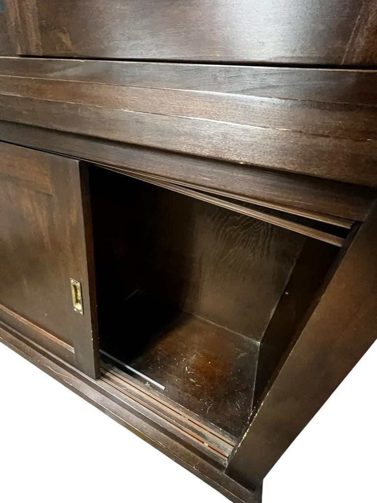 Vintage wooden display cabinet with sliding doors.