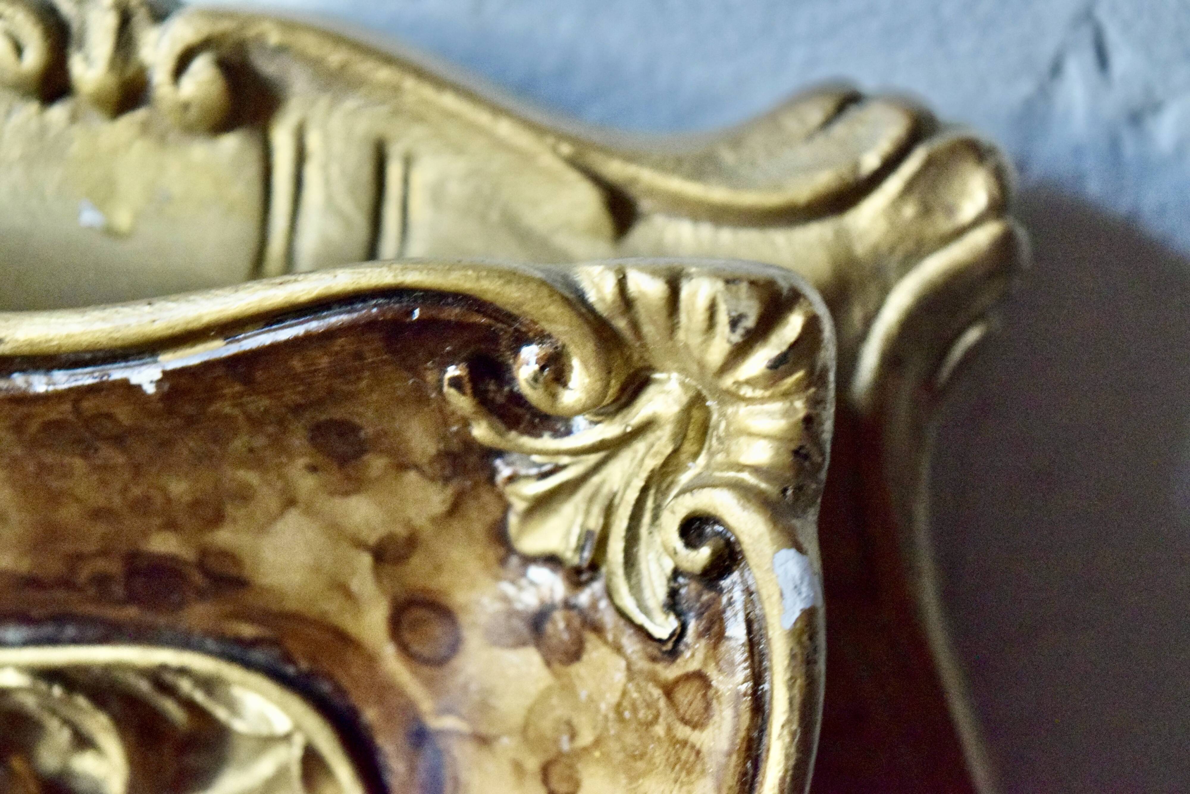 Old religious light frame in gilded stucco and curved glass