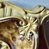 Old religious light frame in gilded stucco and curved glass