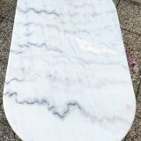 White and black oval marble table, wrought iron base
