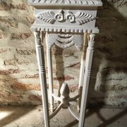 Carved wooden stool with a white patina.