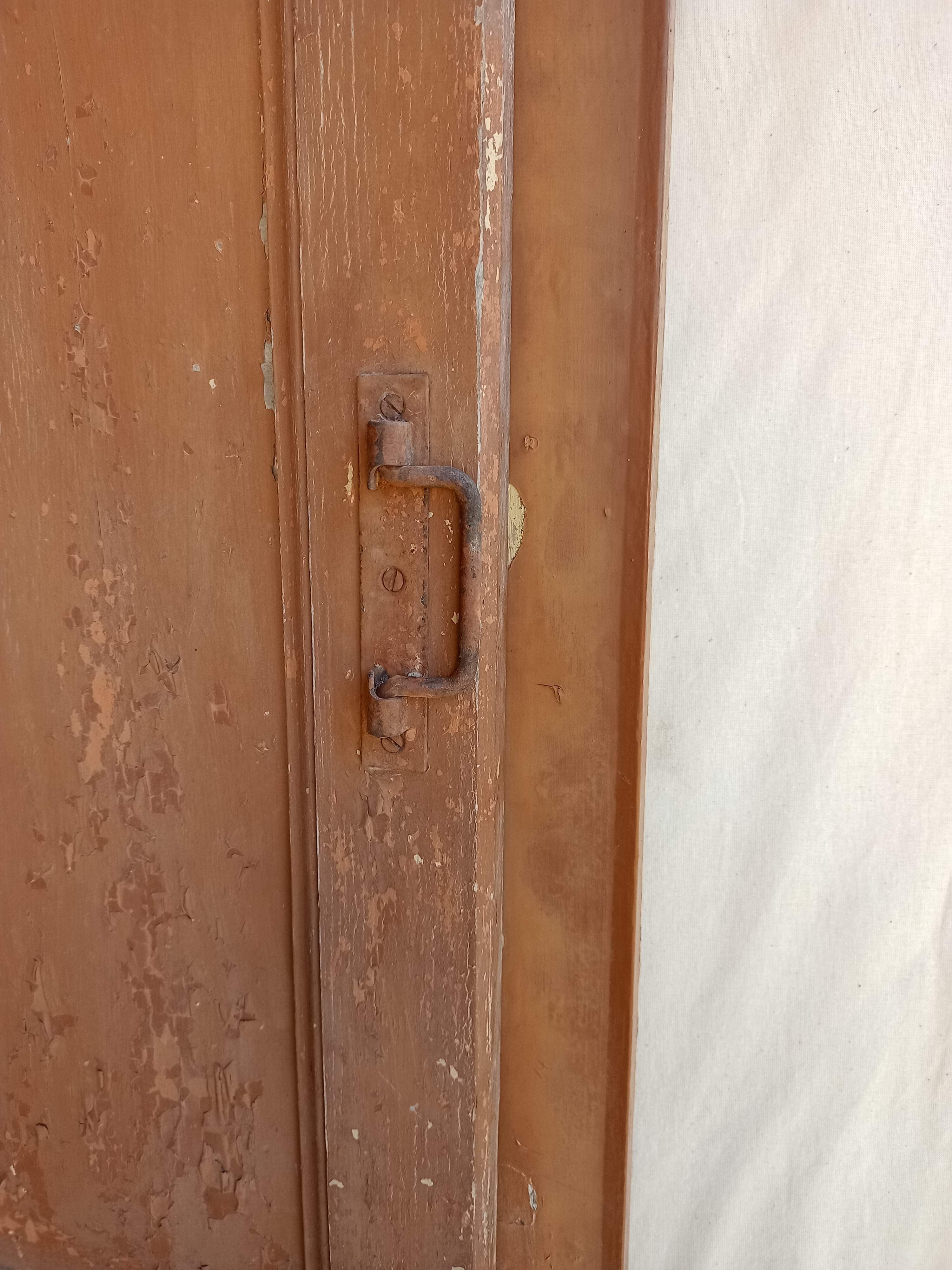 Old glazed door with its shutter