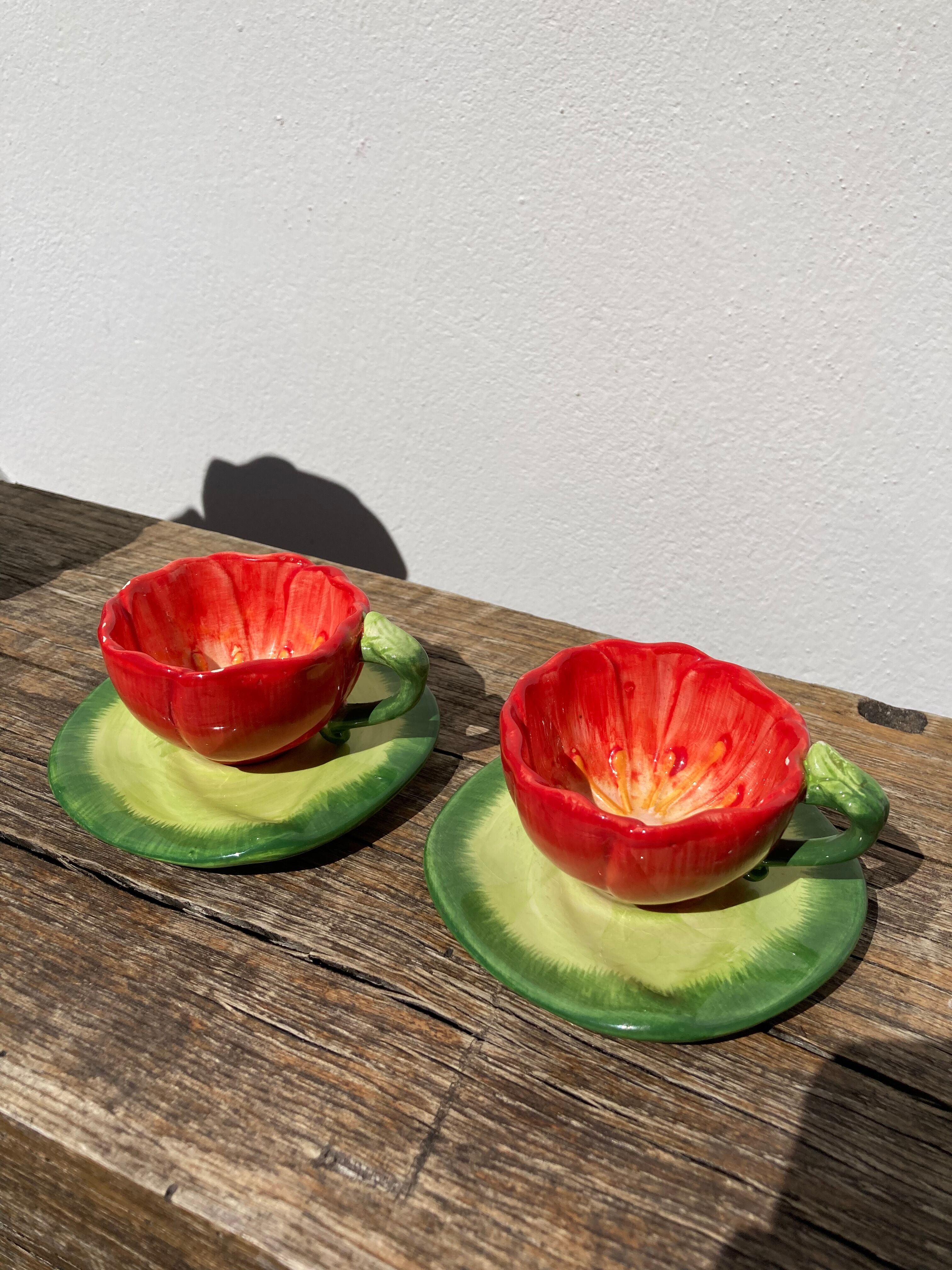 2 coffee cups red flowers and leaf in slurry shepherd