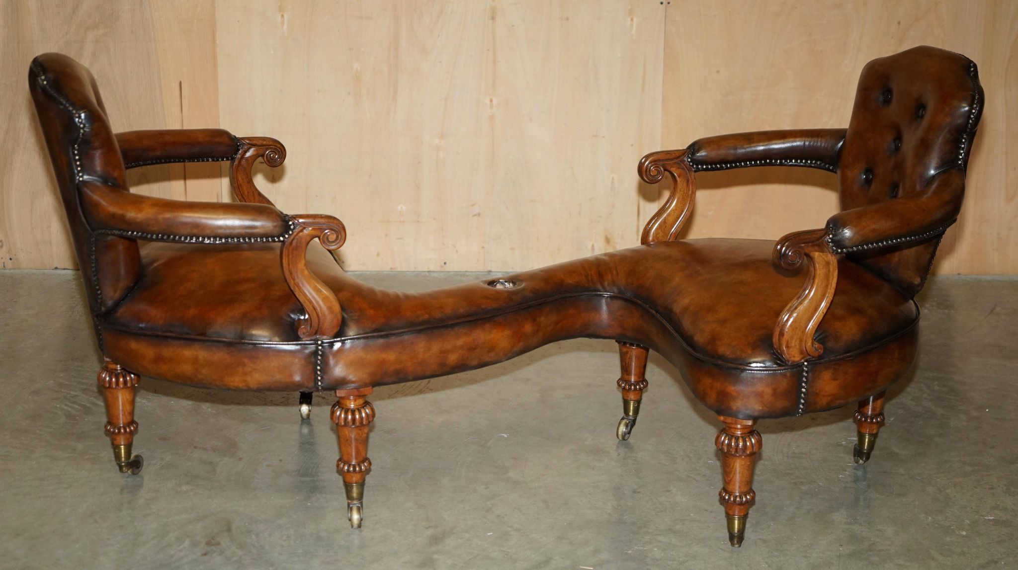 High Victorian leather tête-à-tête canapé with a walnut burr chessboard.