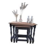 Nest tables in wood and black.