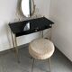 Brass hairdresser, glass and black plastic with its fluffy stool.