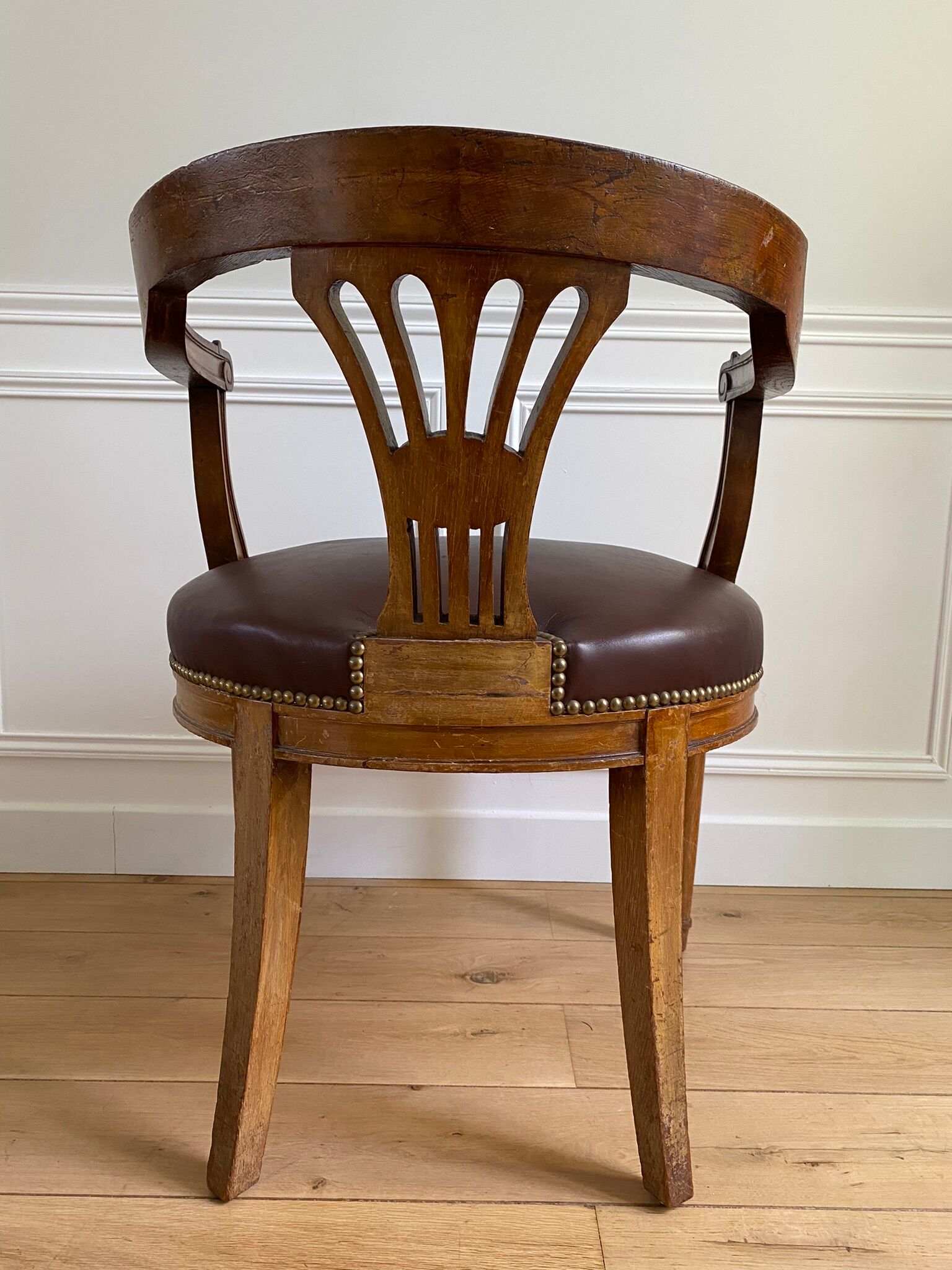 Vintage office chair in wood and brown studded leather late nineteenth