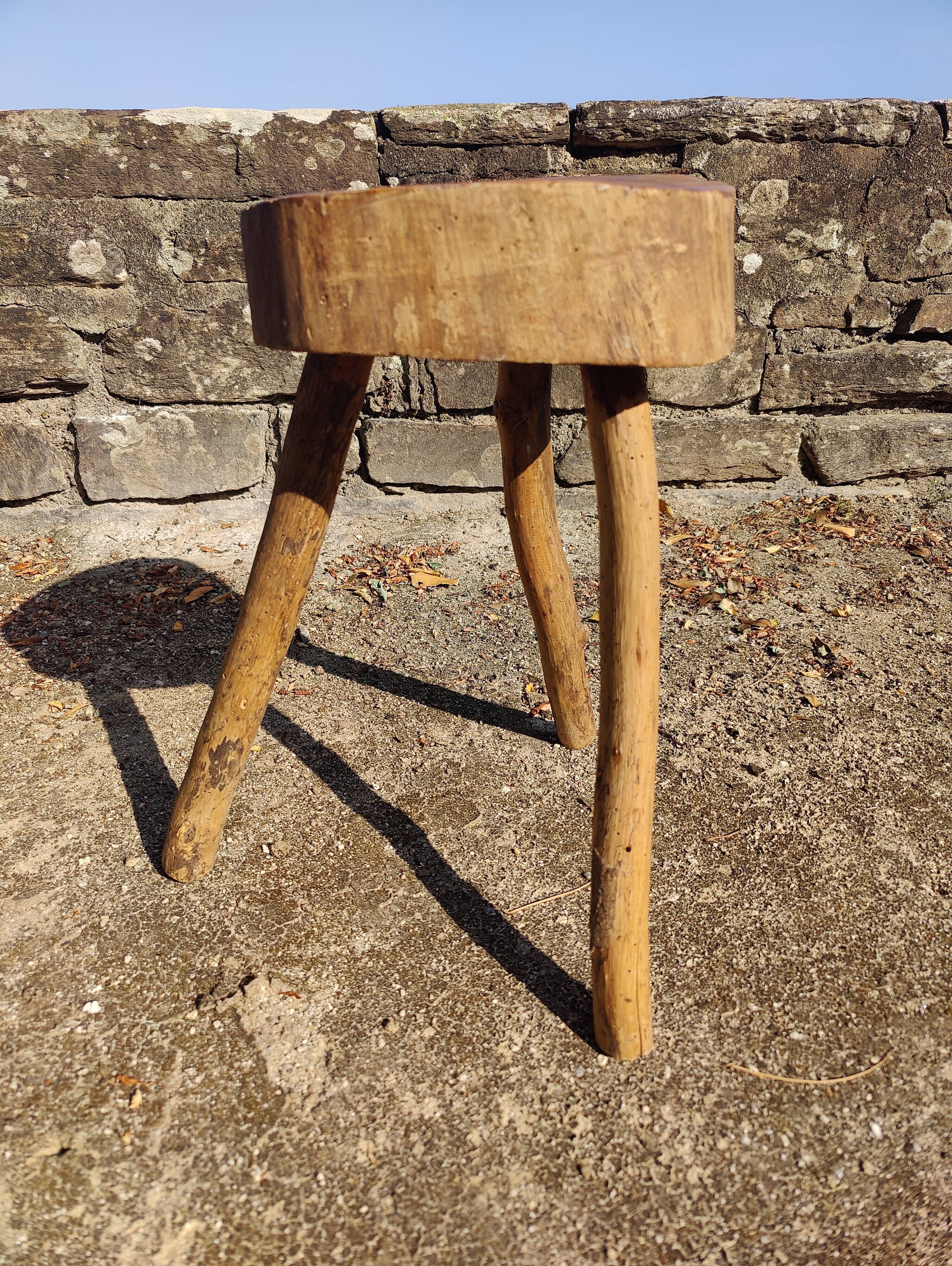 Rustic three-legged stool in minimalist wood in the style of Touret.