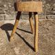 Rustic three-legged stool in minimalist wood in the style of Touret.