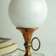 Vintage globe lamp in glass, copper, and brass.