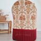 Beige toad armchair with floral patterns and red fringes