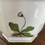 Cover - white ceramic pot decorated with stylized flowers.