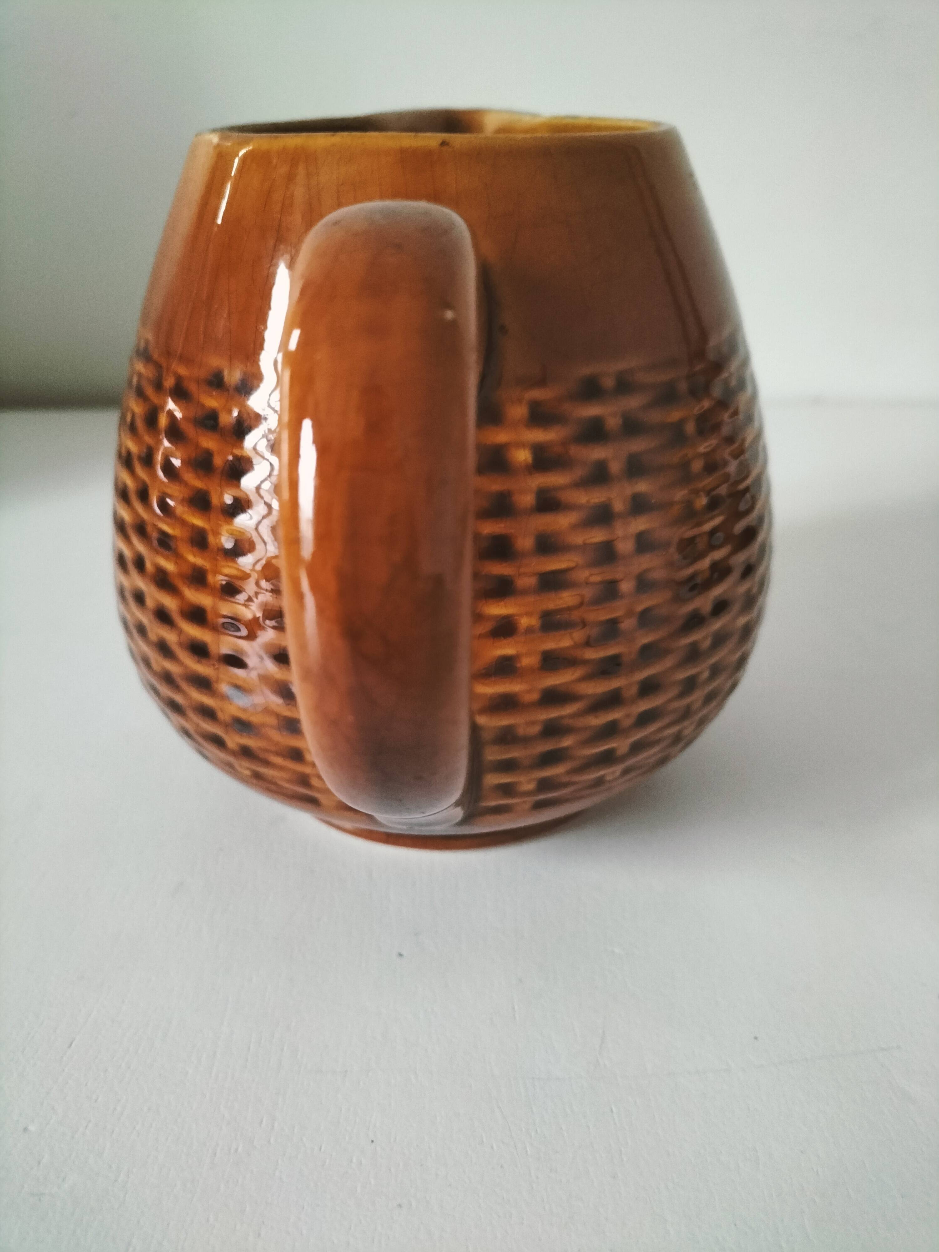 Caramel slipware pitcher with braided relief
