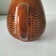 Caramel slipware pitcher with braided relief