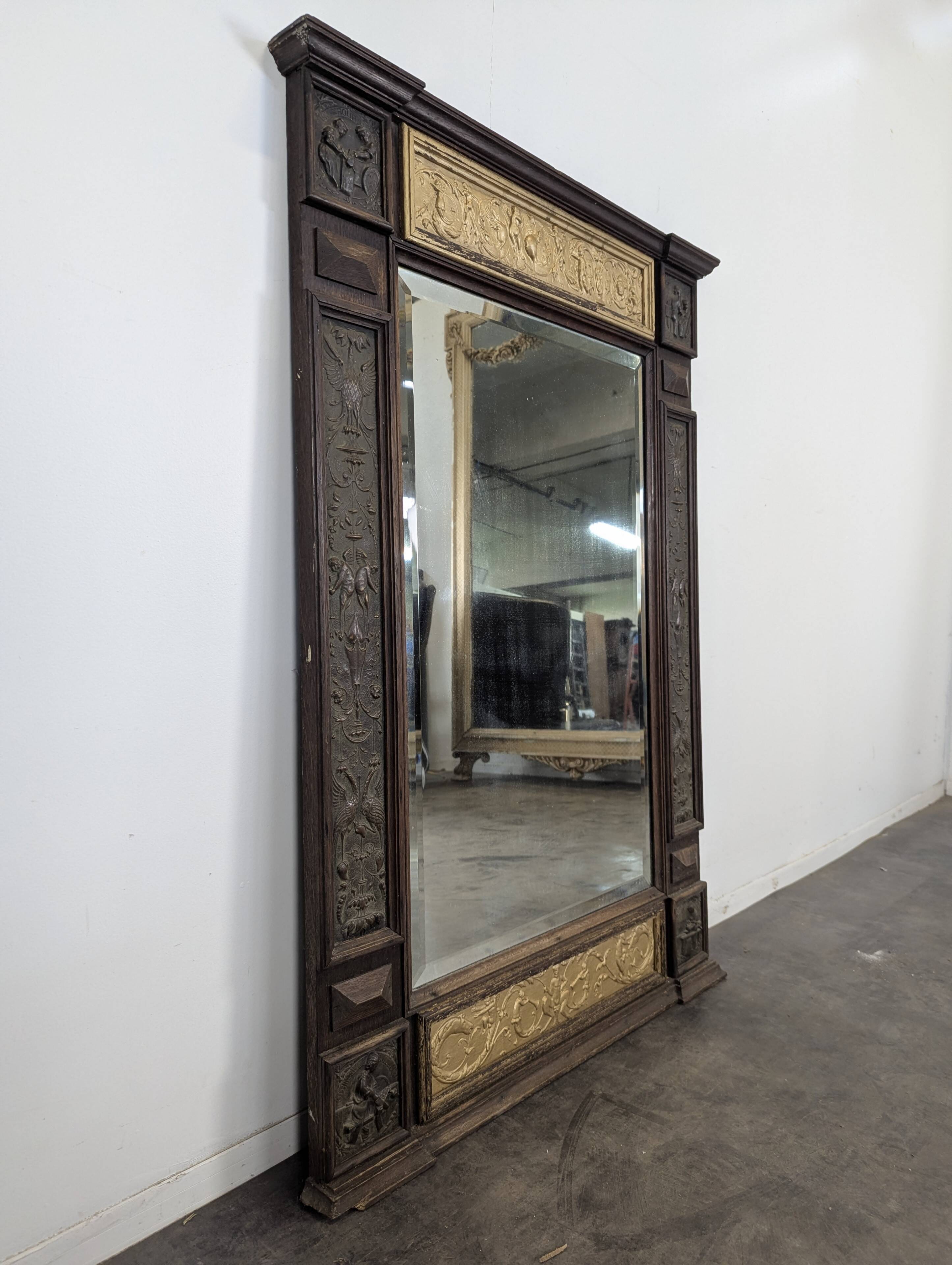 Renaissance-style mirror in wood and copper with a craftsmanship theme.