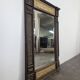 Renaissance-style mirror in wood and copper with a craftsmanship theme.