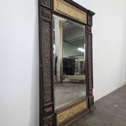Renaissance-style mirror in wood and copper with a craftsmanship theme.