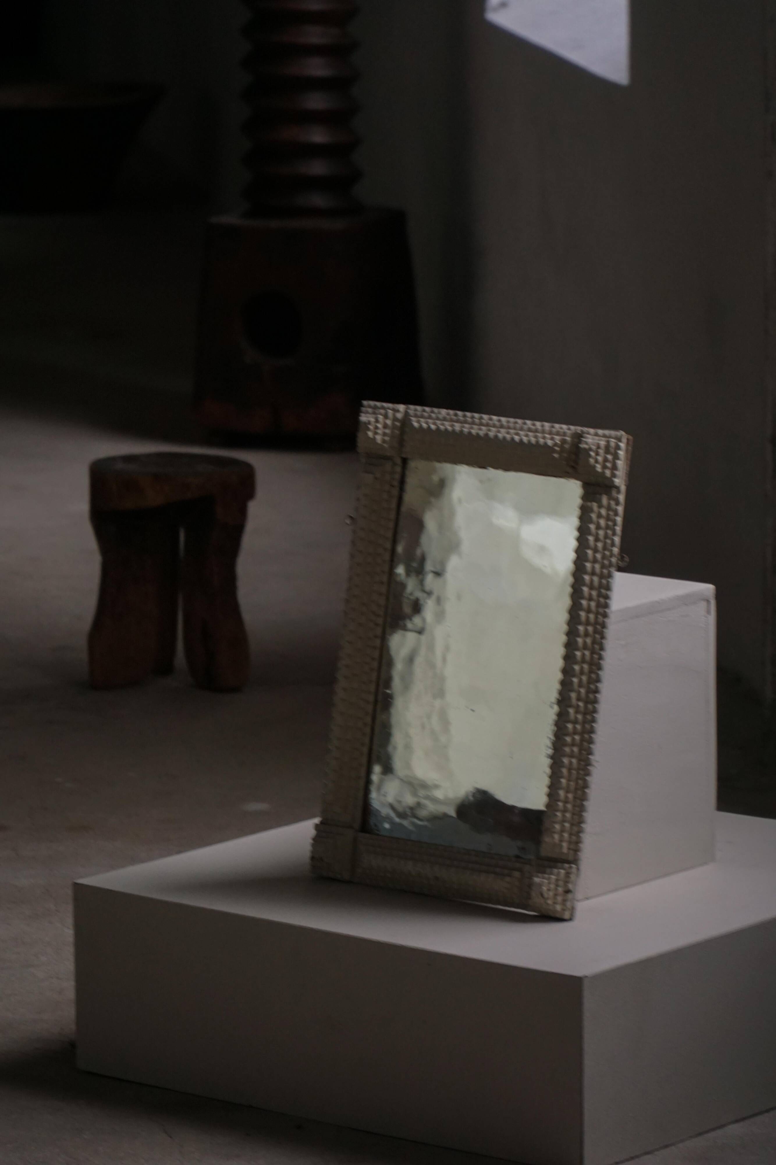 Wall mirror in tramp art style, hand-carved with a painted white frame, early 1900s.